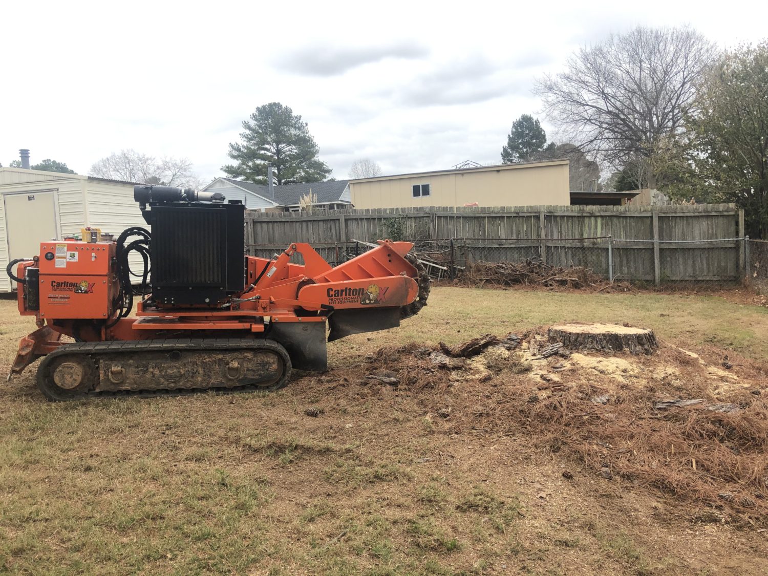 Grinding a stump and the surrounding roots and mound in a backyard in Millbrook, AL